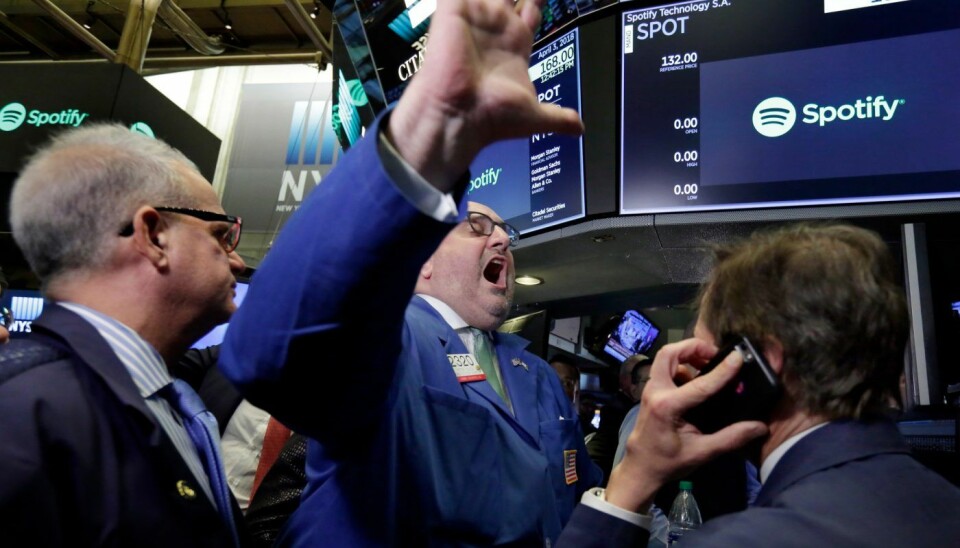 Specialist Peter Giacchi, center, declares Spotify's IPO open on the floor of the New York Stock Exchange, Tuesday, April 3, 2018. Spotify, the No. 1 music streaming service which has drawn comparisons to Netflix, is about to find out how it plays on the stock market in an unusual IPO. (AP Photo/Richard Drew)