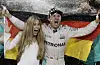 Mercedes driver Nico Rosberg of Germany celebrates with his wife Vivian Sibold holding a German flag in the team garage after winning the F1 2016 Championship in the Emirates Formula One Grand Prix at the Yas Marina racetrack in Abu Dhabi, United Arab Emirates, Sunday, Nov. 27, 2016. (AP Photo/Hassan Ammar)